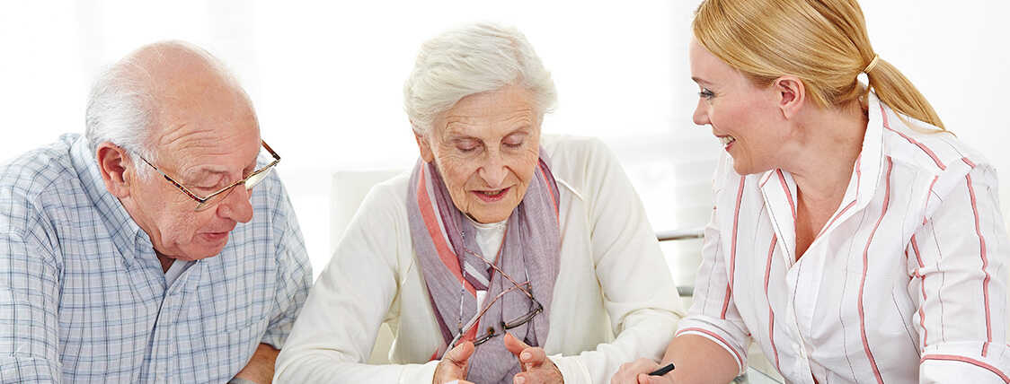 elderly couple meeting with their financial advisor