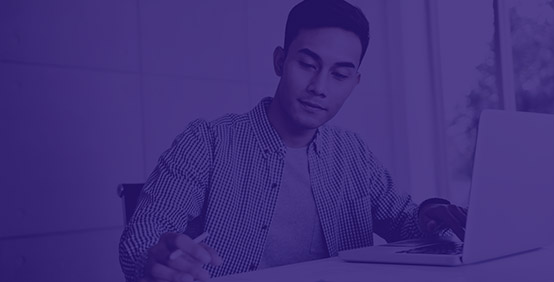 A young professional using Kaplan's Pocket Tables to simplify his taxes