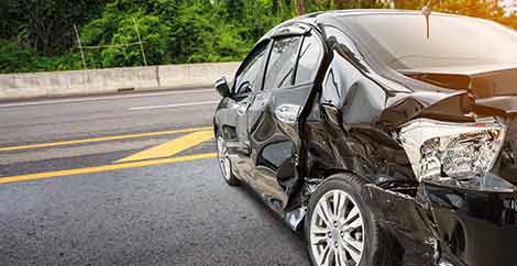 A crashed car that will need to be inspected by an Insurance adjuster