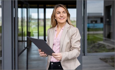 women outside a buidling on a tablet