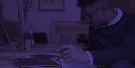 Man studying at his computer with an industry leading Kaplan study experience
