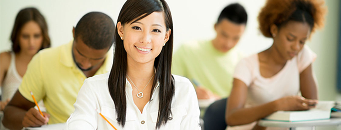 Woman sitting at desk studying for the CFA Exam