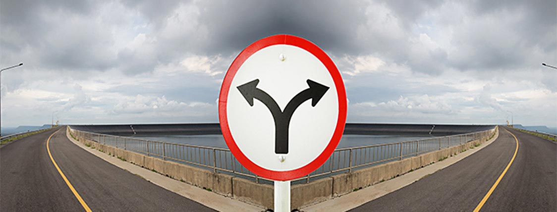 Fork in the road showing a decision - CFA charter versus CAIA charter