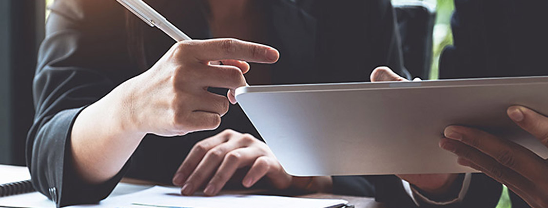 Fund managers checking financials on a tablet