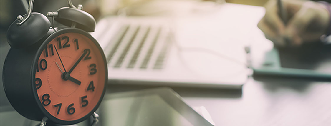 Making the most of 300 hours of CFA Exam study symbolized by clock and study tools