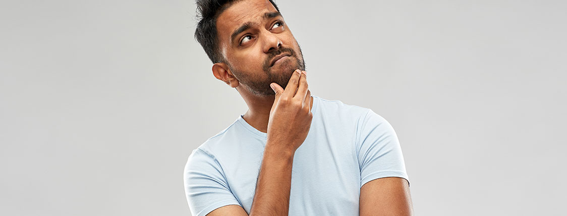 Man with quizzical expression with hand on his chin image