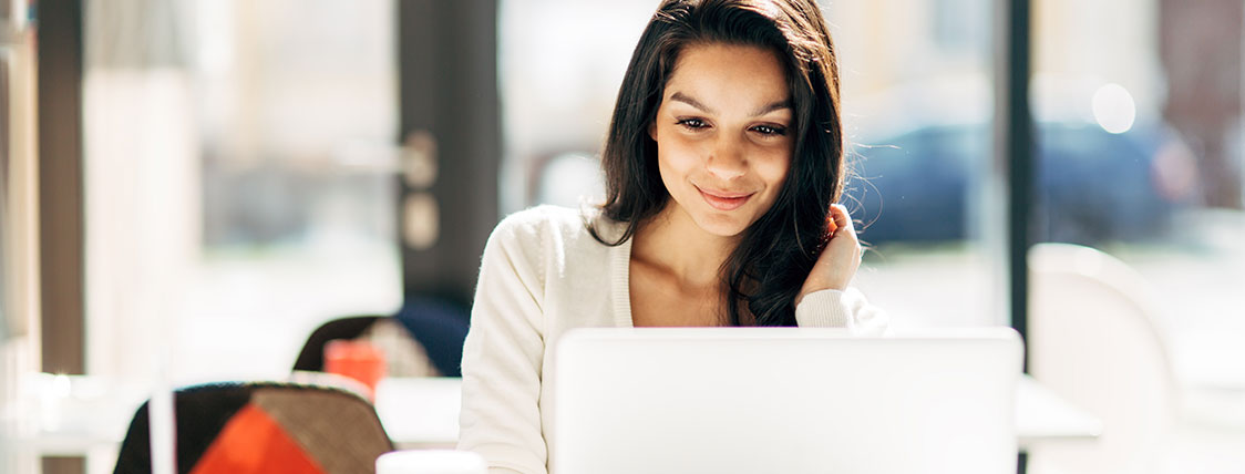 Woman working on a laptop in an open office area image