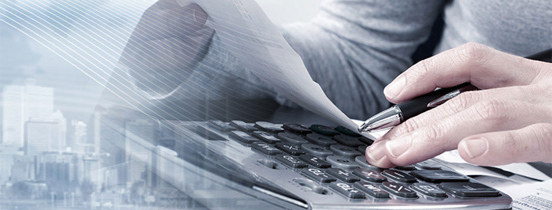 Man at computer working working in a CAIA Charterholder career