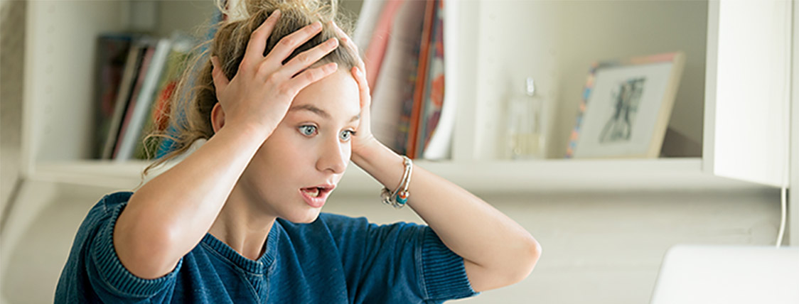 Woman holding head because of making one of the five common study mistakes on the CAIA exam