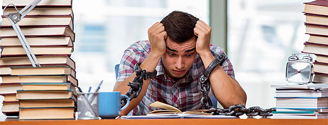 Man overwhelmed while studying the CFA Exam