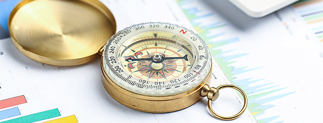 Compass on financial papers indicating a decision - CFA Charter versus FINRA Series 7