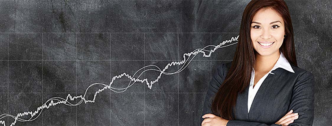 Female Portfolio manager standing in front of chalkboard