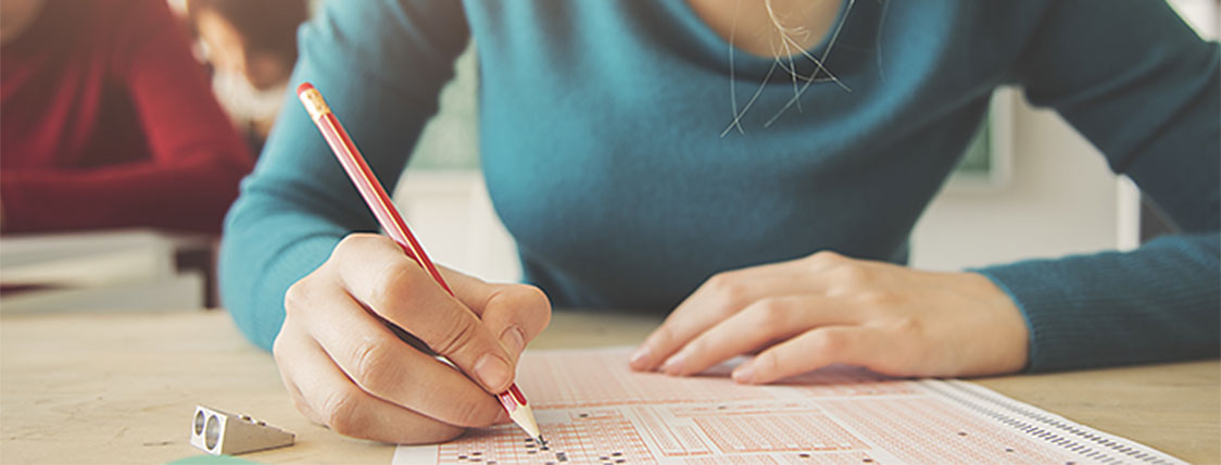 Woman sitting for a CFA mock exam to prepare for the CFA Program exam